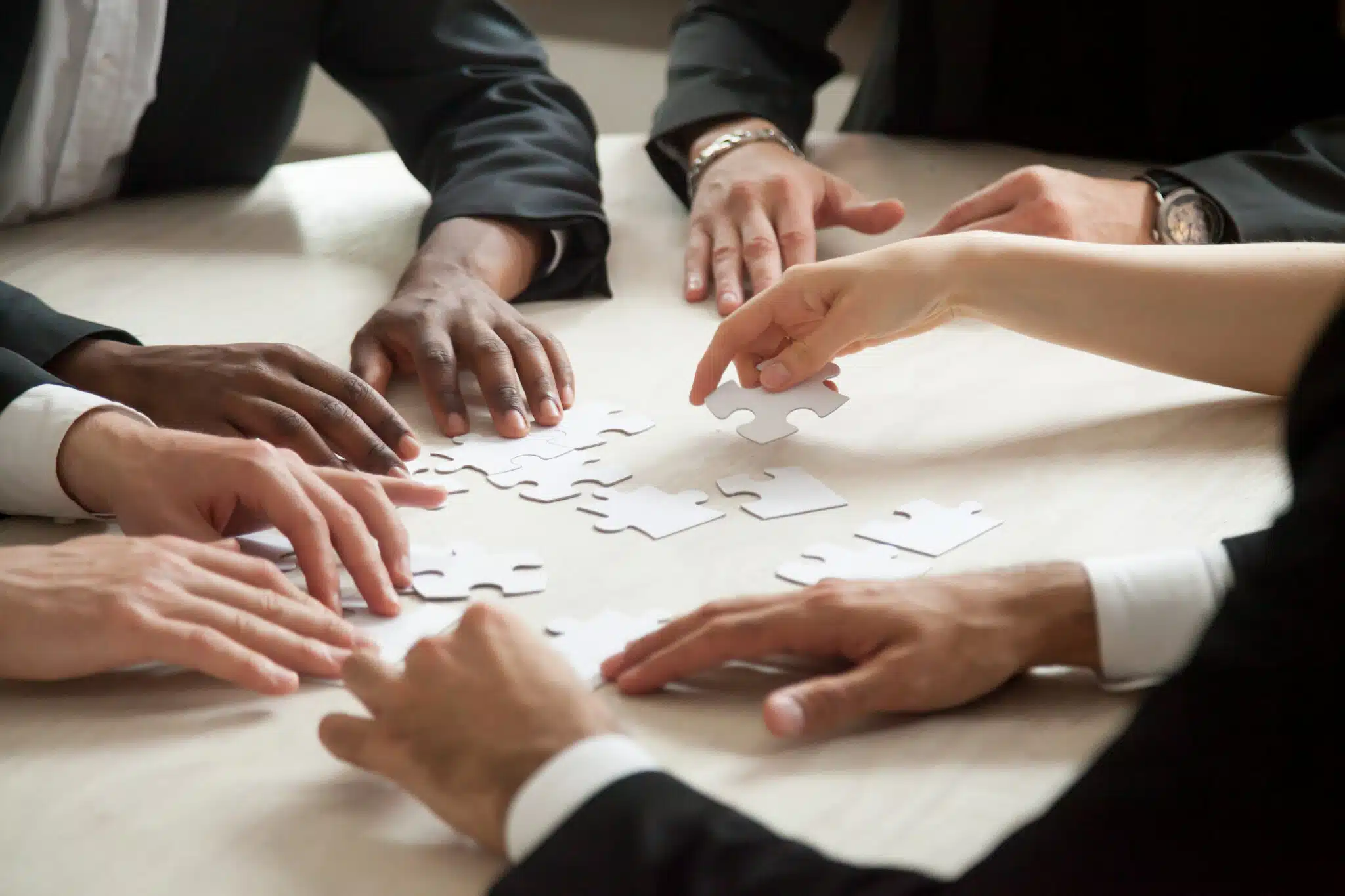 About Copago Marketplace 2 close up multiethnic team solving blank puzzle game scaled